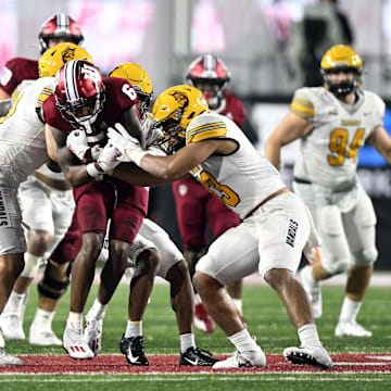 Indiana Hoosiers wide receiver Cam Camper (6) is tackled by multiple Idaho Vandals players during the second half at Memorial Stadium. The Hoosiers won 35-22 in one of its games against a FCS opponent.