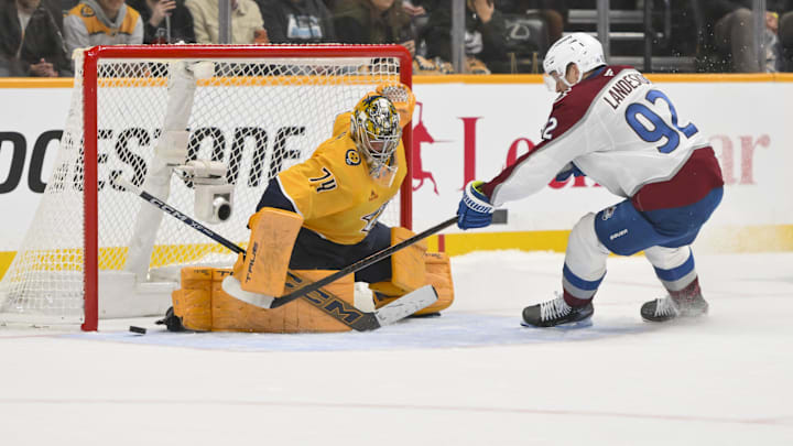 Dec 9, 2025; Nashville, Tennessee, USA;  Nashville Predators goaltender Juuse Saros (74) blocks the shot of Colorado Avalanche left wing Gabriel Landeskog (92) during the shootout at Bridgestone Arena. Mandatory Credit: Steve Roberts-Imagn Images