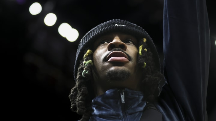 Jan 24, 2024; Miami, Florida, USA; Memphis Grizzlies guard Ja Morant (12) looks on from the sideline against the Miami Heat during the fourth quarter at Kaseya Center. 