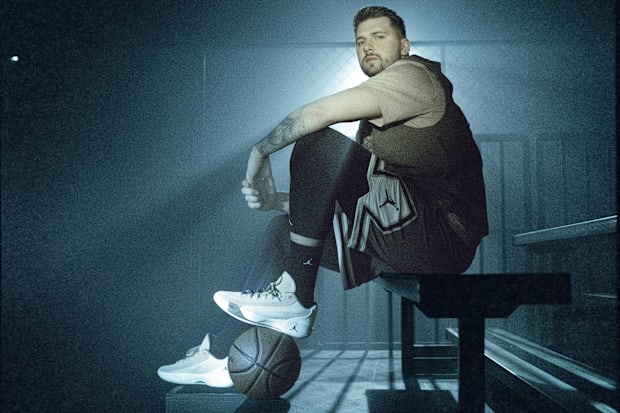 Luka Dončić models white and brown sneakers.