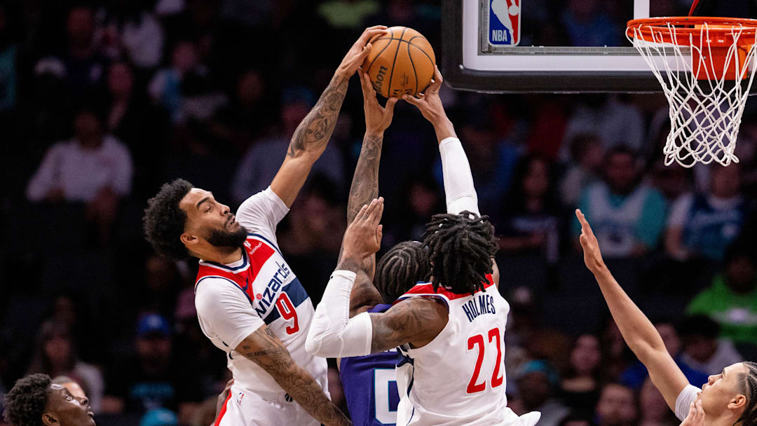 Mar 1, 2025; Charlotte, North Carolina, USA; Washington Wizards forward Justin Champagnie (9) and forward Richaun Holmes (22) block a shot from Charlotte Hornets forward Miles Bridges (0) during the third quarter at Spectrum Center. Mandatory Credit: Scott Kinser-Imagn Images