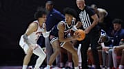 Dec 14, 2024; Salt Lake City, Utah, USA; Radford Highlanders guard Jarvis Moss (11) holds the ball away from Utah Utes guard Miro Little (1) during the second half at Jon M. Huntsman Center. Mandatory Credit: Rob Gray-Imagn Images