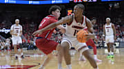 Nov 26, 2025; Louisville, Kentucky, USA;  Louisville Cardinals guard Adrian Wooley (14) dribbles against NJIT Highlanders guard Jeremy Clayville (2) during the first half at KFC Yum! Center. Mandatory Credit: Jamie Rhodes-Imagn Images