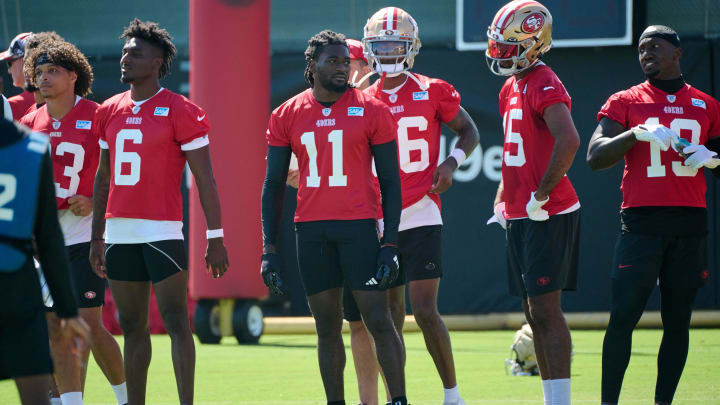 Jul 27, 2023; Santa Clara, CA, USA; San Francisco 49ers wide receiver Brandon Aiyuk (11) stands on the field with his teammates during training camp at the SAP Performance Facility. Mandatory Credit: Robert Edwards-USA TODAY Sports