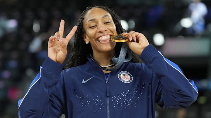 Aug 11, 2024; Paris, France; United States forward A'Ja Wilson (9) celebrates with the gold medal after defeating France in the women's gold medal game during the Paris 2024 Olympic Summer Games at Accor Arena. 