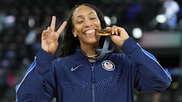 Aug 11, 2024; Paris, France; United States forward A'Ja Wilson (9) celebrates with the gold medal after defeating France in the women's gold medal game during the Paris 2024 Olympic Summer Games at Accor Arena. Mandatory Credit: Kyle Terada-Imagn Images