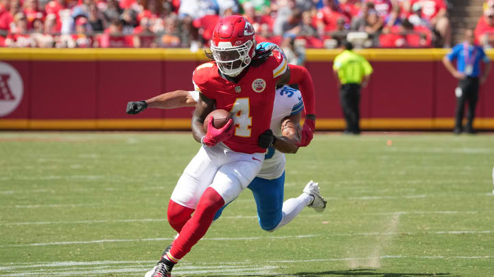 Aug 17, 2024; Kansas City, Missouri, USA; Kansas City Chiefs wide receiver Rashee Rice (4) runs the ball as Detroit Lions cornerback Khalil Dorsey (30) chases during the first half at GEHA Field at Arrowhead Stadium. Mandatory Credit: Denny Medley-USA TODAY Sports