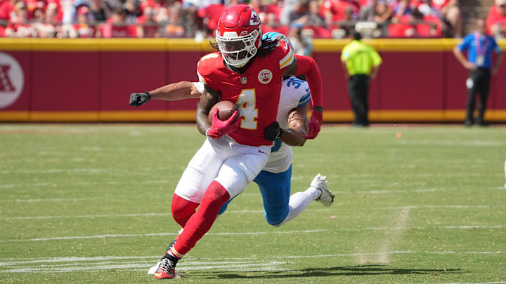 Aug 17, 2024; Kansas City, Missouri, USA; Kansas City Chiefs wide receiver Rashee Rice (4) runs the ball as Detroit Lions cornerback Khalil Dorsey (30) chases during the first half at GEHA Field at Arrowhead Stadium. Mandatory Credit: Denny Medley-Imagn Images