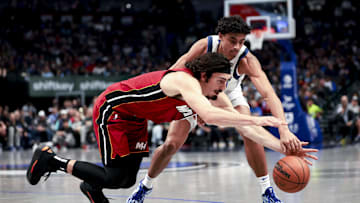 Feb 13, 2025; Dallas, Texas, USA;  Dallas Mavericks guard Max Christie (00) and Miami Heat guard Jaime Jaquez Jr. (11) go for a loose ball during the first half at American Airlines Center. Mandatory Credit: Kevin Jairaj-Imagn Images