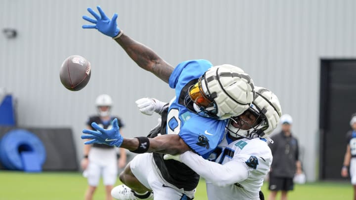 Jul 30, 2024; Charlotte, NC, USA; Carolina Panthers wide receiver David Moore (83) reaches out for a catch against  cornerback Kiondre Thomas (35) during training camp at Carolina Panthers Practice Fields. Mandatory Credit: Jim Dedmon-USA TODAY Sports