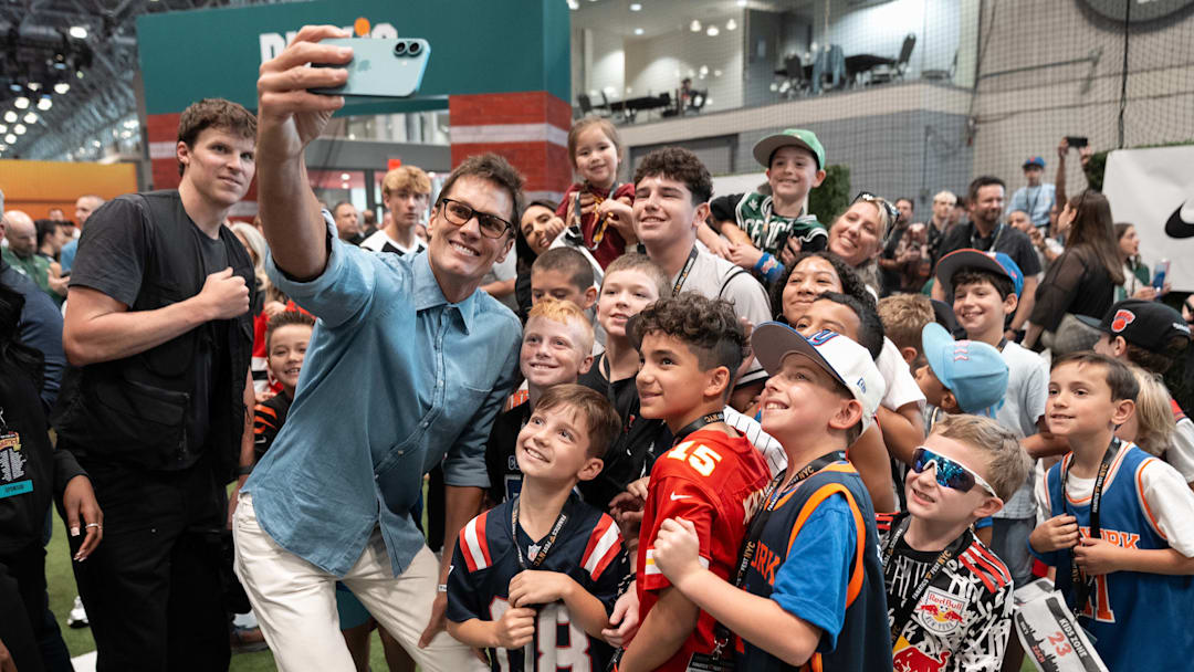 Tom Brady takes a selfie with the crowd at the 2025 Fanatics Fest event.