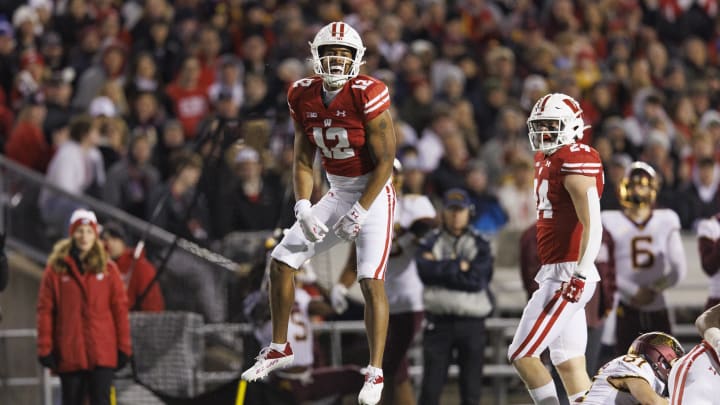 Nov 26, 2022; Madison, Wisconsin, USA;  Wisconsin Badgers cornerback Max Lofy (12) celebrates following a tackle during the third quarter against the Minnesota Golden Gophers at Camp Randall Stadium. Mandatory Credit: Jeff Hanisch-USA TODAY Sports