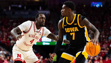 Mar 9, 2025; Lincoln, Nebraska, USA; Iowa Hawkeyes forward Seydou Traore (7) drives against Nebraska Cornhuskers forward Juwan Gary (4) during the second half at Pinnacle Bank Arena. Mandatory Credit: Dylan Widger-Imagn Images