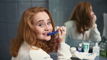 A person brushing their teeth