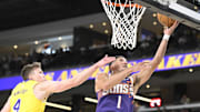 Oct 3, 2025; Palm Desert, California, USA; Phoenix Suns guard Devin Booker (1) shoots past Los Angeles Lakers guard Dalton Knecht (4) at Acrisure Arena. Mandatory Credit: Denis Poroy-Imagn Images