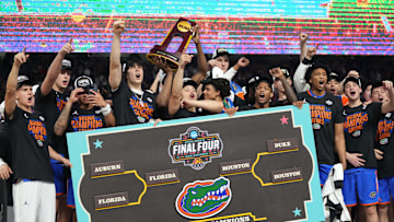 Apr 7, 2025; San Antonio, TX, USA;  Florida Gators players celebrate with the trophy after defeating the Houston Cougars in the national championship game of the Final Four of the 2025 NCAA Tournament at the Alamodome. Mandatory Credit: Robert Deutsch-Imagn Images