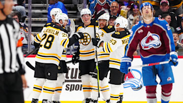 Oct 16, 2024; Denver, Colorado, USA; Boston Bruins right wing David Pastrnak (88) celebrates his goal with center Elias Lindholm (28), left wing Brad Marchand (63), and center Trent Frederic (11) in the second period against the Colorado Avalanche at Ball Arena. Mandatory Credit: Ron Chenoy-Imagn Images