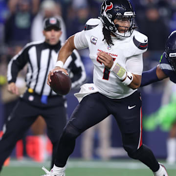 Oct 20, 2025; Seattle, Washington, USA; Houston Texans quarterback C.J. Stroud (7) is chased by Seattle Seahawks linebacker Uchenna Nwosu (7) during the first quarter at Lumen Field. Mandatory Credit: Kevin Ng-Imagn Images