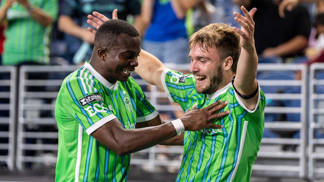 Seattle Sounders forward Pedro de la Vega (10), right, celebrates with defender Nouhou Tolo (5)