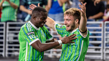 Seattle Sounders forward Pedro de la Vega (10), right, celebrates with defender Nouhou Tolo (5)