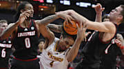 Nov 22, 2024; Louisville, Kentucky, USA;  Louisville Cardinals forward James Scott (0) and forward Noah Waterman (93) battle Winthrop Eagles forward Kelton Talford (4) for a rebound during the first half at KFC Yum! Center.