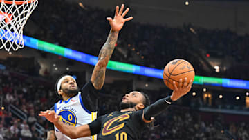 Gary Payton II contests Darius Garland's layup attempt during a game between the Golden State Warriors and Cleveland Cavaliers