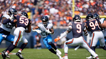 Tennessee Titans running back Tony Pollard (20) runs through the Chicago Bears defense on his way to a touchdown at Soldier Field in Chicago, Ill., Sunday, Sept. 8, 2024.