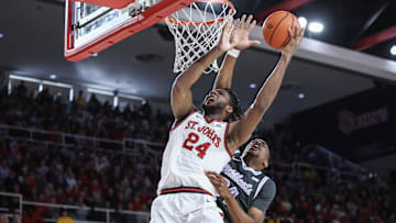 Dec 7, 2024; Queens, New York, USA;  St. John's basketball forward Zuby Ejiofor (24) drives past Kansas State Wildcats center Ugonna Onyenso (34) in the second half at Carnesecca Arena. 