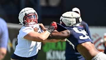 Jul 23, 2025; Foxborough, MA, USA; New England Patriots offensive tackle Will Campbell (66) and defensive end Keion White (99) work on a drill during training camp at Gillette Stadium. Mandatory Credit: Eric Canha-Imagn Images