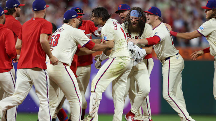Oct 6, 2024; Philadelphia, Pennsylvania, USA; Philadelphia Phillies outfielder Nick Castellanos (8) celebrates with teammates after hitting a walk off game winning RBI single.