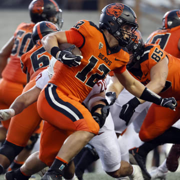 Oct 15, 2022; Corvallis, Oregon, USA; Oregon State Beavers inside linebacker Jack Colletto (12) runs the ball against Washington State Cougars defensive end Quinn Roff (20) during the first half at Reser Stadium. Mandatory Credit: Soobum Im-USA TODAY Sports