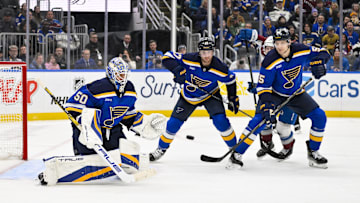 Feb 23, 2025; St. Louis, Missouri, USA;  St. Louis Blues goaltender Jordan Binnington (50) defenseman Cam Fowler (17) and defenseman Colton Parayko (55) defend the net against the Colorado Avalanche during the third period at Enterprise Center. Mandatory Credit: Jeff Curry-Imagn Images