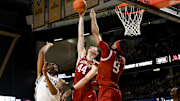Mar 4, 2025; Nashville, Tennessee, USA;  Arkansas Razorbacks forward Zvonimir Ivisic (44) blocks the shot of  Vanderbilt Commodores forward Devin McGlockton (99) during the first half at Memorial Gymnasium. Mandatory Credit: Steve Roberts-Imagn Images