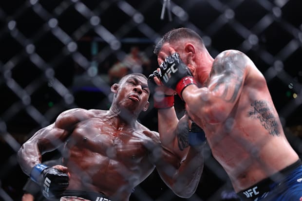 Colby Covington (red gloves) fights Joaquin Buckley (blue gloves) at Amalie Arena. 
