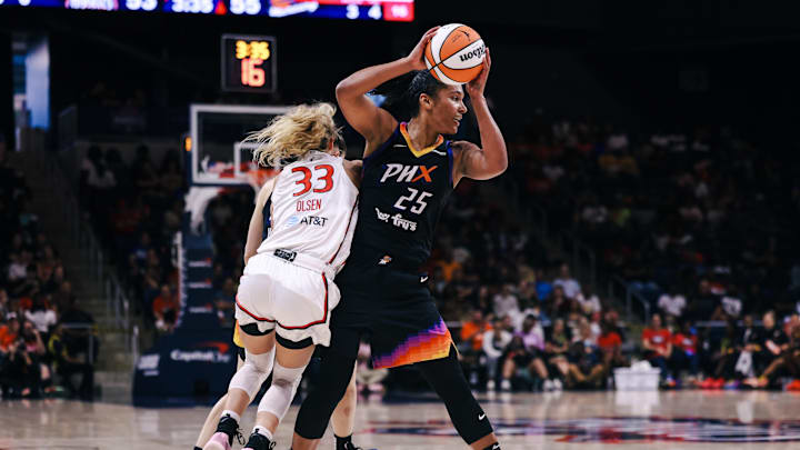 Jul 27, 2025; Washington, District of Columbia, USA; Phoenix Mercury forward Alyssa Thomas (25) controls the ball while Washington Mystics guard Lucy Olsen (33) defends in the third quarter at CareFirst Arena. Mandatory Credit: Emily Faith Morgan-Imagn Images