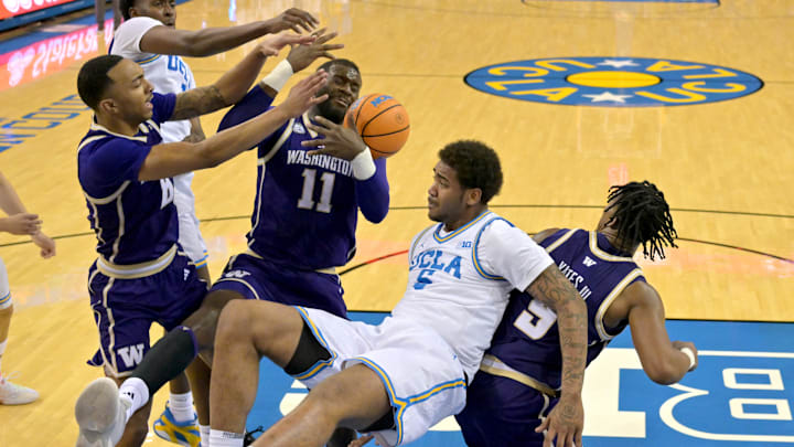 Feb 7, 2026; Los Angeles, California, USA;  Washington Huskies center Franck Kepnang (11), forward Bryson Tucker (8) and UCLA Bruins forward Xavier Booker (1) and guard Brandon Williams (5) go for a rebound in the first half at Pauley Pavilion presented by Wescom Financial. Mandatory Credit: Jayne Kamin-Oncea-Imagn Images