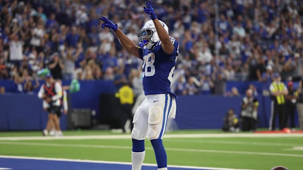 Colts running back Jonathan Taylor (Blue and White Uniform) celebrates after scoring a touchdown.