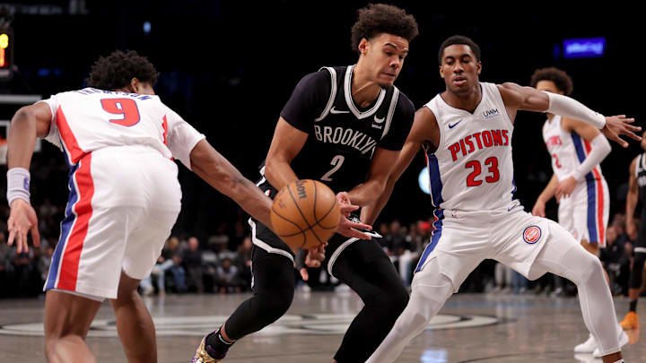 Dec 23, 2023; Brooklyn, New York, USA; Detroit Pistons forward Ausar Thompson (9) knocks the ball away from Brooklyn Nets forward Cameron Johnson (2) as he drives to the basket against Pistons guard Jaden Ivey (23): Brad Penner-USA TODAY Sports