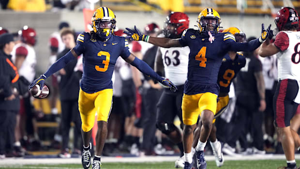 Cal defensive back Nohl Williams (left) celebrates with defensive back Miles Williams (right) after intercepting a pass.