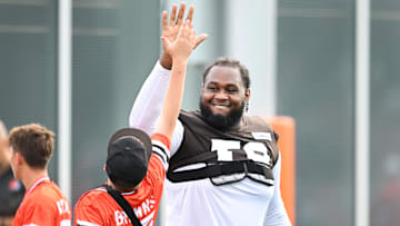 Jul 26, 2025; Berea, OH, USA; Cleveland Browns offensive tackle Dawand Jones (79) high-fives a fan during training camp at CrossCountry Mortgage Campus. Mandatory Credit: Ken Blaze-Imagn Images
