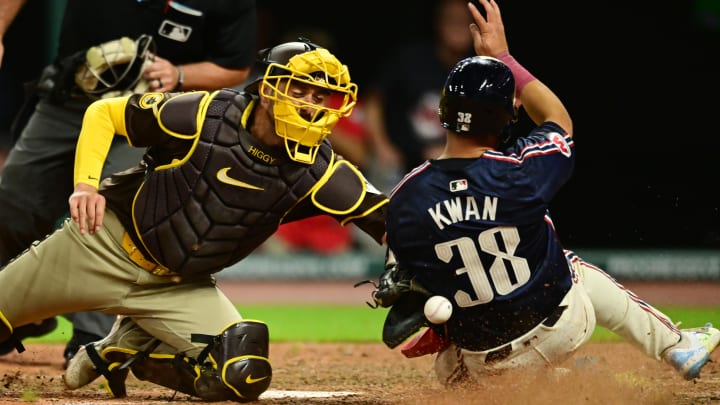 Jul 19, 2024; Cleveland, Ohio, USA; Cleveland Guardians left fielder Steven Kwan (38) slides into home as San Diego Padres catcher Kyle Higashioka (20) loses the ball during the eighth inning at Progressive Field. Mandatory Credit: Ken Blaze-USA TODAY Sports