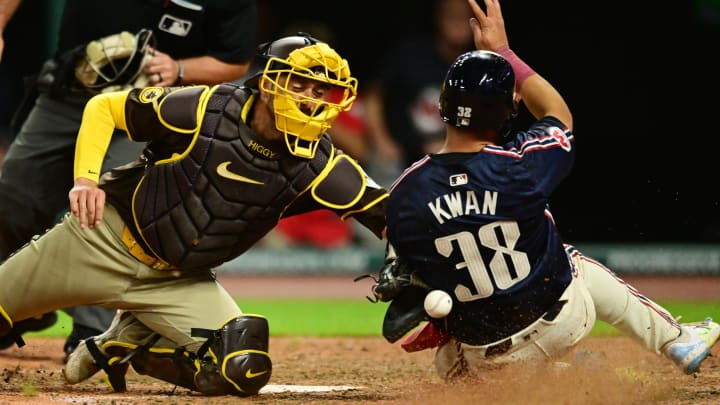 Jul 19, 2024; Cleveland, Ohio, USA; Cleveland Guardians left fielder Steven Kwan (38) slides into home as San Diego Padres catcher Kyle Higashioka (20) loses the ball during the eighth inning at Progressive Field. Mandatory Credit: Ken Blaze-USA TODAY Sports