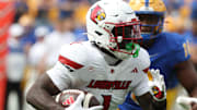 Sep 27, 2025; Pittsburgh, Pennsylvania, USA;  Louisville Cardinals running back Isaac Brown (1) runs the ball against the Pittsburgh Panthers during the first quarter at Acrisure Stadium. Mandatory Credit: Charles LeClaire-Imagn Images