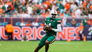 Nov 2, 2024; Miami Gardens, Florida, USA; Miami Hurricanes quarterback Cam Ward (1) looks for a passing option against the Duke Blue Devils during the first quarter at Hard Rock Stadium. Mandatory Credit: Sam Navarro-Imagn Images