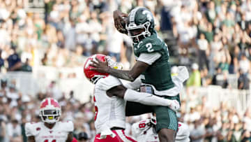 Sep 13, 2025; East Lansing, Michigan, USA; Michigan State quarterback Aidan Chiles (2) attempts to vault over Youngstown State linebacker Solomon Farrell (16) in the fourth quarter at Spartan Stadium. Mandatory Credit: Brendan Mullin-Imagn Images