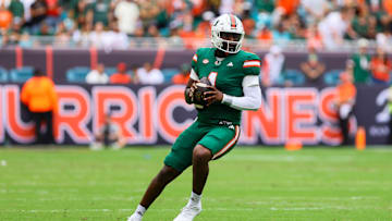 Nov 2, 2024; Miami Gardens, Florida, USA; Miami Hurricanes quarterback Cam Ward (1) looks for a passing option against the Duke Blue Devils during the first quarter at Hard Rock Stadium. Mandatory Credit: Sam Navarro-Imagn Images