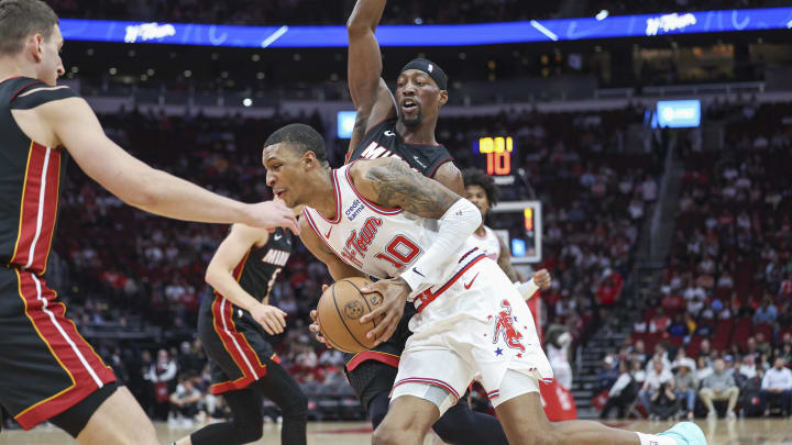 Apr 5, 2024; Houston, Texas, USA; Houston Rockets forward Jabari Smith Jr. (10) drives with the ball as Miami Heat center Bam Adebayo (13) defends during the first quarter at Toyota Center. Mandatory Credit: Troy Taormina-USA TODAY Sports