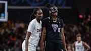 Atlanta Dream guard Shatori Walker-Kimbrough smiles on the court with Golden State Valkyries guard Tiffany Hayes 