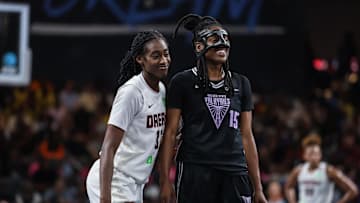 Atlanta Dream guard Shatori Walker-Kimbrough smiles on the court with Golden State Valkyries guard Tiffany Hayes 