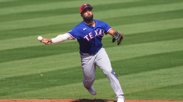 Mar 9, 2026; Peoria, Arizona, USA; Texas Rangers shortstop Ezequiel Duran (20) throws to first base against the San Diego Padres during the third inning at Peoria Sports Complex. Mandatory Credit: Joe Camporeale-Imagn Images